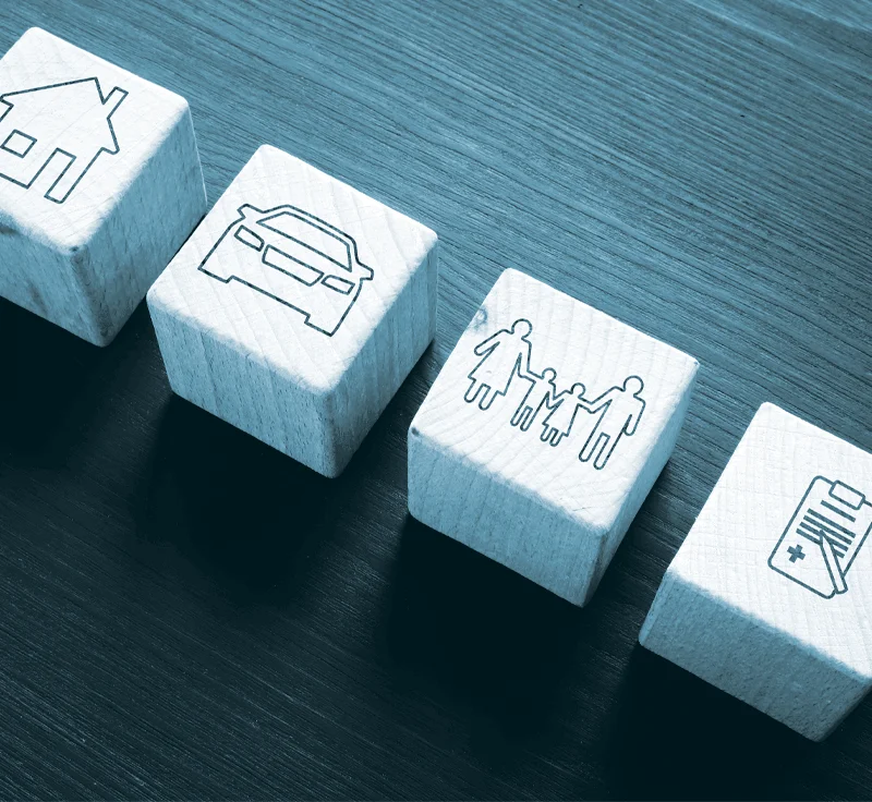 Blocks with house, car, family, and chart laying next to each other